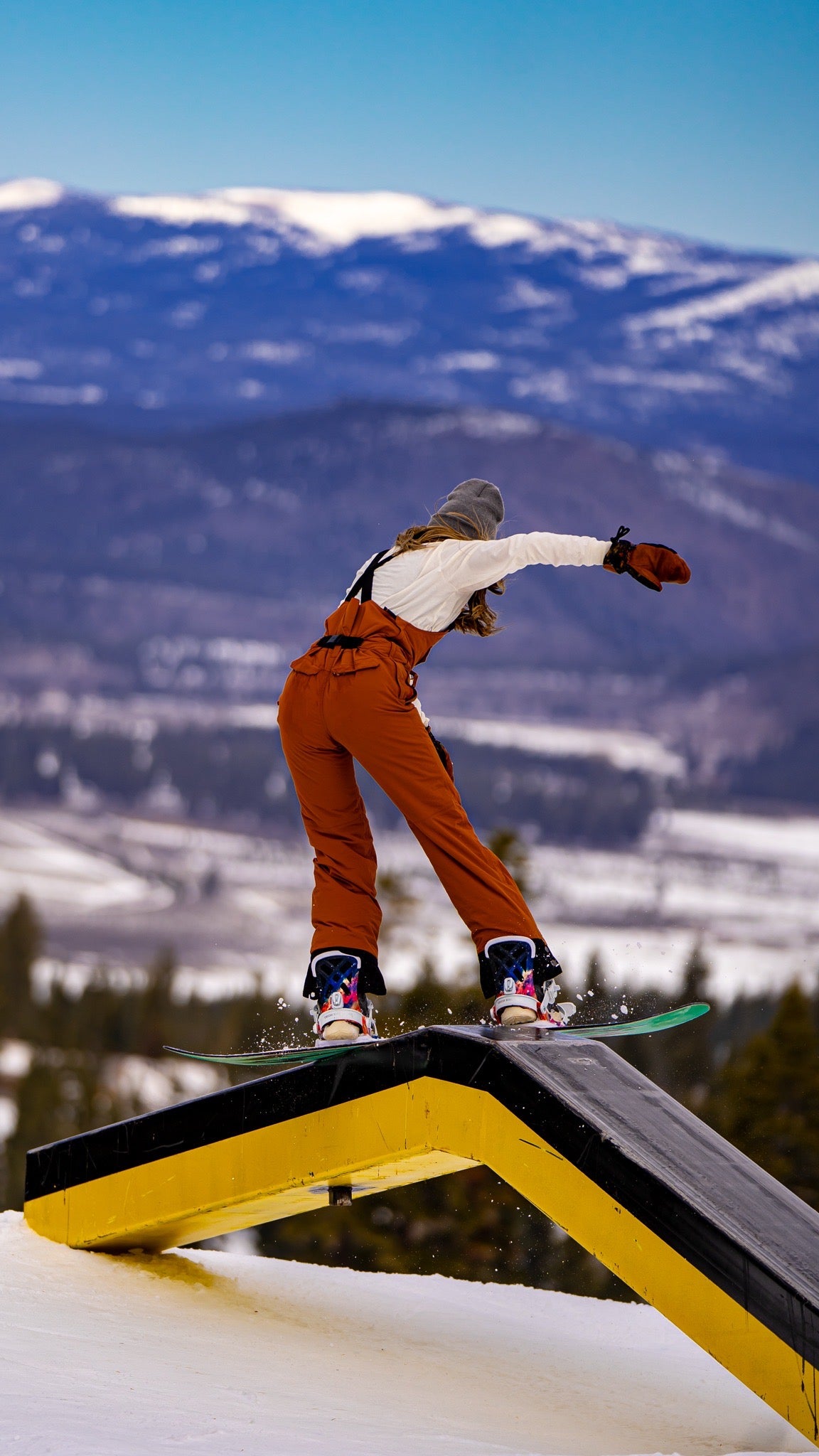 Bib belt on girl snowboarding in park
