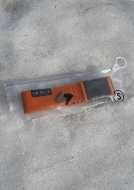 small burnt orange bib belt in the snow