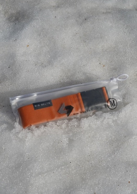 medium orange bib belt in the snow