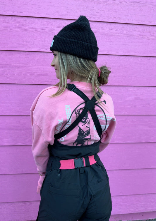 girl wearing a pink bib belt for ski and snowboarding